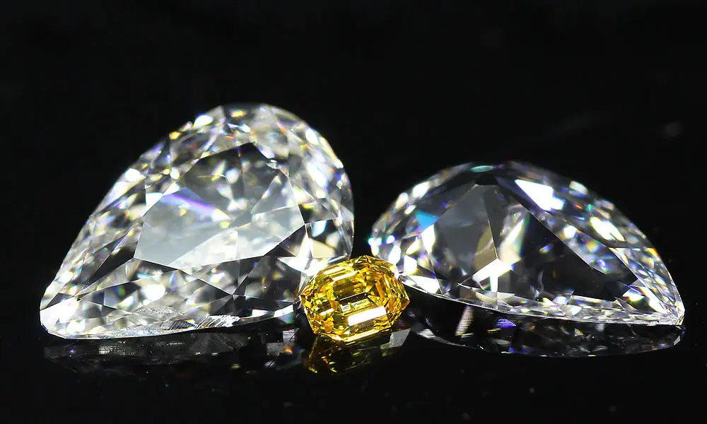 Mismatched Pair of Old Mine Pear Cut Diamonds facing