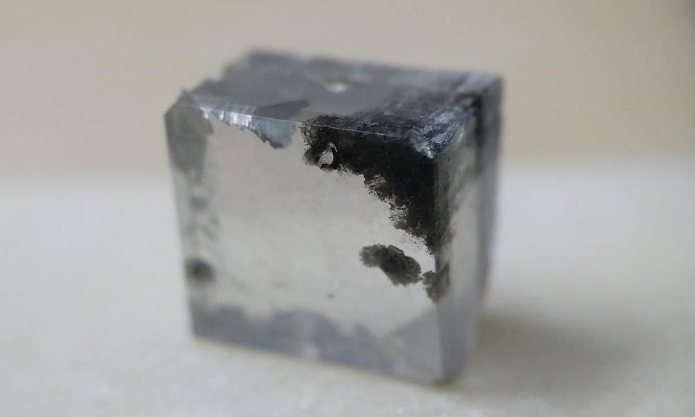 Dark polycrystalline penetrating the diamond material which cant be manually cut out